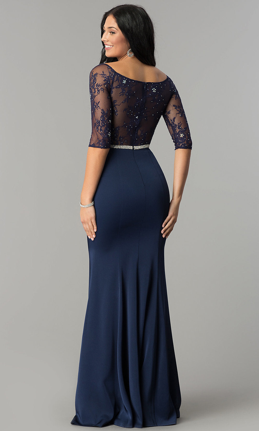 Woman wearing the Three-Quarter-Sleeve Lace-Bodice Long Prom Dress in navy blue, featuring a sheer, beaded lace bodice and shown from the back against a plain gray background.